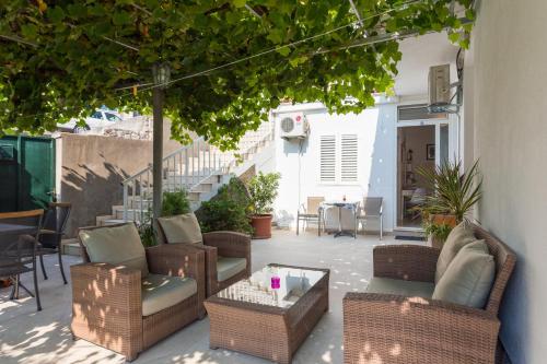 a patio with wicker chairs and a table at Guesthouse S&L in Dubrovnik