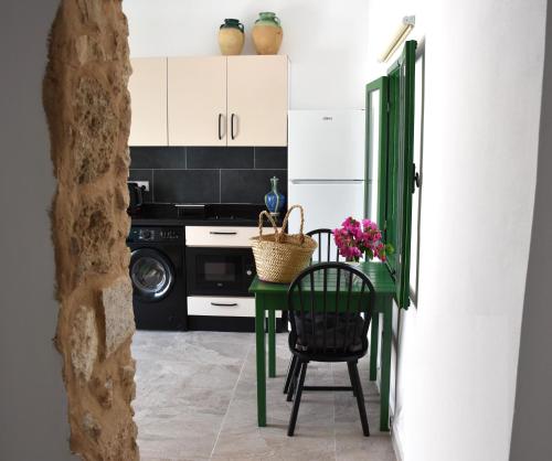 a green table and chairs in a kitchen at Stone Suites in Famagusta
