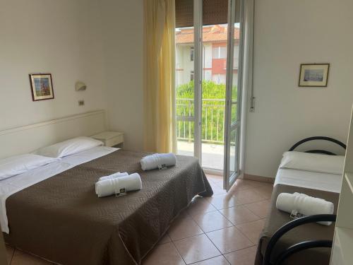 a bedroom with a bed with two towels on it at Hotel Primula in Lido di Savio