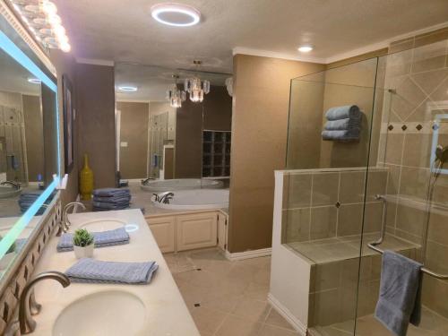 a bathroom with a sink and a shower and a tub at Lakefront Retreat, Pool, Hottub, Firepit in Azle