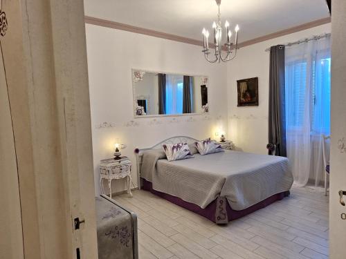 a bedroom with a bed with two tables and a mirror at DolceMorfeo in Olbia
