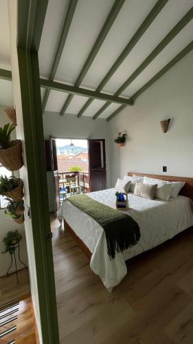 a bedroom with a large bed in a room at Hotel Casa Dulces del Jardín in Jardin