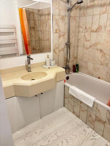 a bathroom with a sink and a bath tub at New,mountain & sea view 3 guests with private Garage in Beausoleil