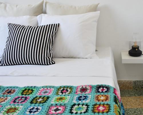 a bed with two pillows and a blanket on it at Stone Suites in Famagusta