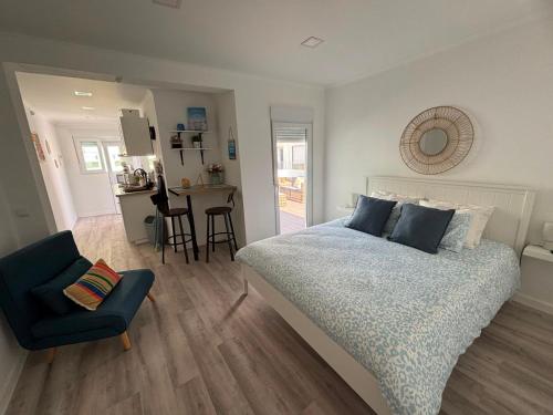 a bedroom with a bed and a chair and a table at Blessed House in Portimão