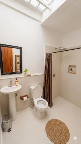 a bathroom with a toilet and a sink at La Toscana Hostel in Villa de Leyva
