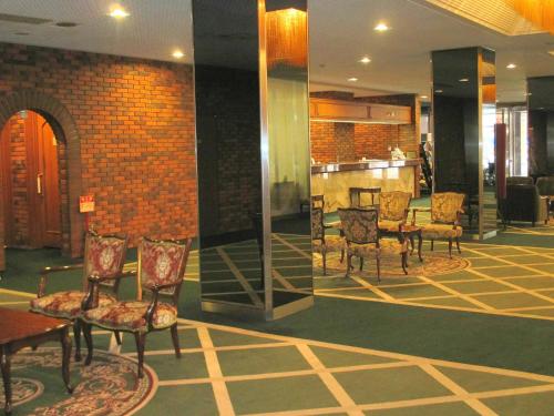 a lobby with chairs and a bar in a building at Muroran Prince Hotel in Muroran