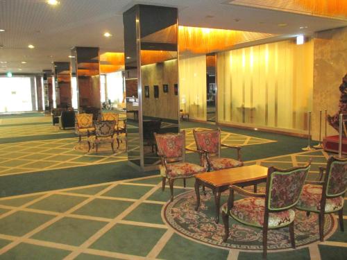
a dining room with tables, chairs, and tables at Muroran Prince Hotel in Muroran
