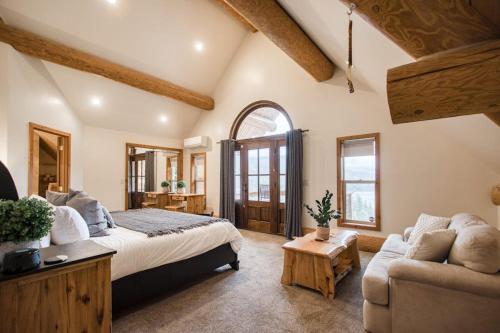 a large bedroom with a bed and a couch at Sagle Sunrise in Sagle