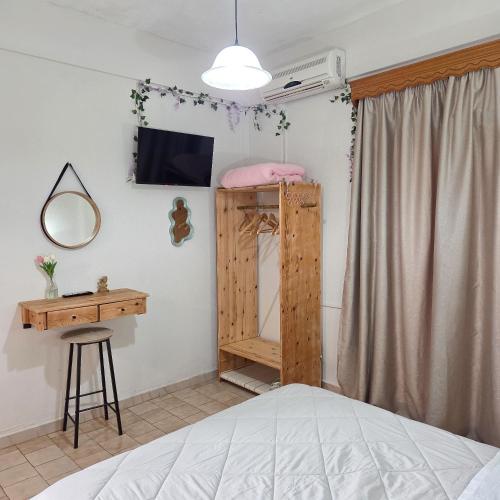a bedroom with a bunk bed and a desk and a bed at Chrysanthi Melitsa apts. in Sidari