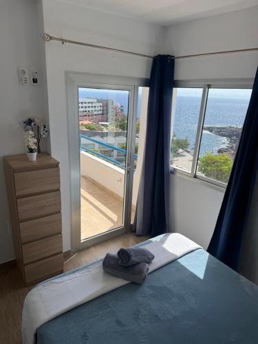 a bedroom with a bed and a view of the ocean at La Estrella del Sur in Adeje