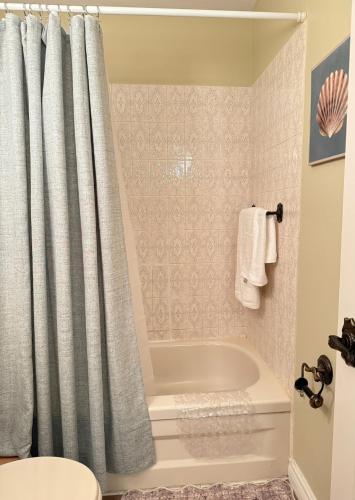 a bathroom with a tub and a shower curtain at Private Guest Suit-Self Checkin-Near Downtown in Charlottetown