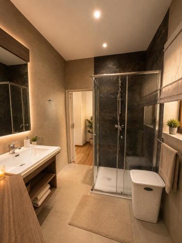 a bathroom with a shower and a toilet and a sink at Sliema Arch Suites Modern Boutique Apartment in St. Julianʼs
