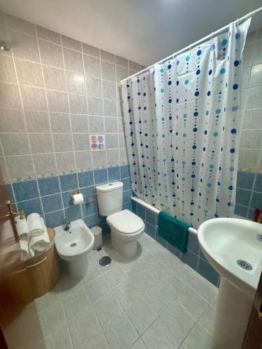 a bathroom with a toilet and a sink at Oasis de Málaga in Chilches