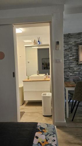 a bathroom with a sink and a mirror at Apartments No 55 in Baška