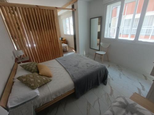 a bedroom with a large bed with pillows on it at A Porta Verde in O Grove