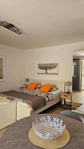 a bedroom with a large bed and a table at Apartments No 55 in Baška