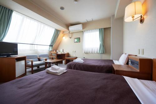 Ліжко або ліжка в номері Select Inn Yaizu Ekimae