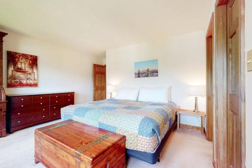 a bedroom with a bed and a dresser and a table at Mountain Vista in Bartlett
