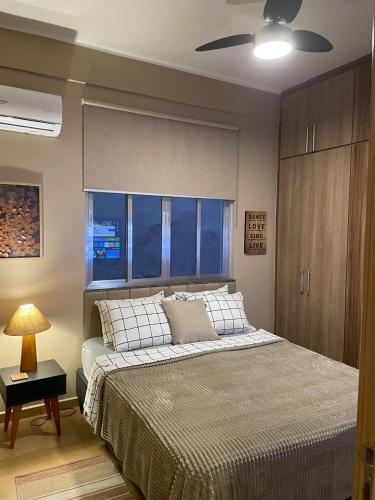 a bedroom with a bed and a ceiling fan at BeM Ipanema in Rio de Janeiro