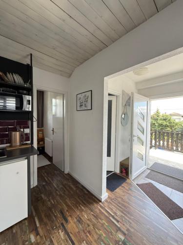 a living room with white walls and a wooden floor at Studio apartman Gradna in Samobor