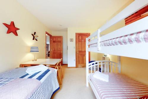 a bedroom with two bunk beds and a desk at Eagle Ridge Escape in Bartlett