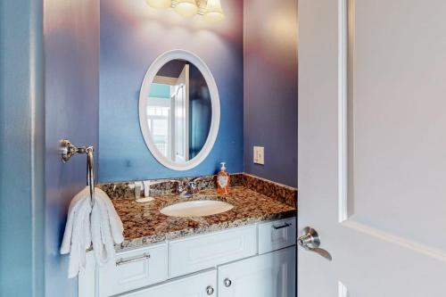 a bathroom with a sink and a mirror at Hampton Beach Beauty in Hampton