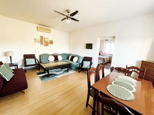a living room with a table and a couch at Apartment by the lake in Píšťany