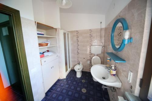 a small bathroom with a sink and a toilet at Villa Troianiello in Carano