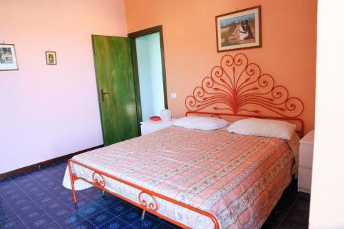 a bedroom with a bed with an ornate headboard at Villa Troianiello in Carano