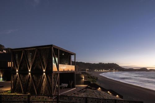 a building on the beach near the water at Qbos Matanzas in Matanzas