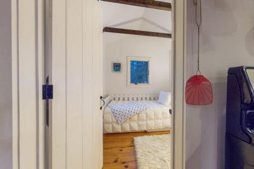 a bedroom with a bed in a room with a door at Little Red in Wilmington