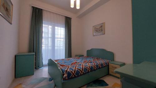 a bedroom with a bed and a window at Orges Apartament in Struga