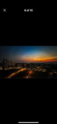 a plane is flying over a city at sunset at Cozy private bedroom and bathroom in Surrey