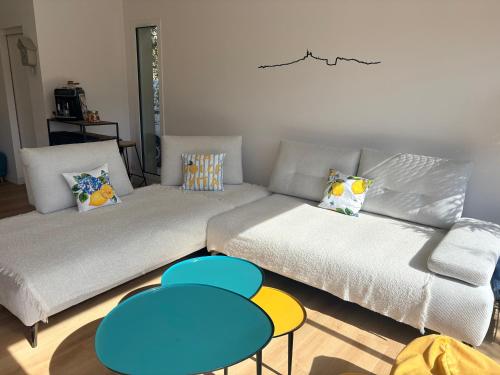 a living room with a couch and two tables at Villa dolce vita in Nans-les-Pins