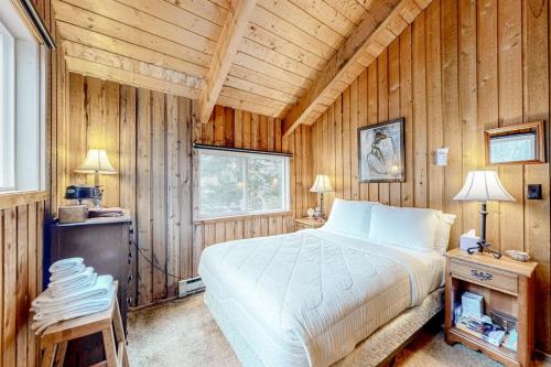 a bedroom with a bed in a wooden room at Mowing Way Retreat in Wilmington