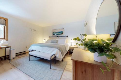 a large bedroom with a bed and a large mirror at White Mountain Chalet in Bartlett