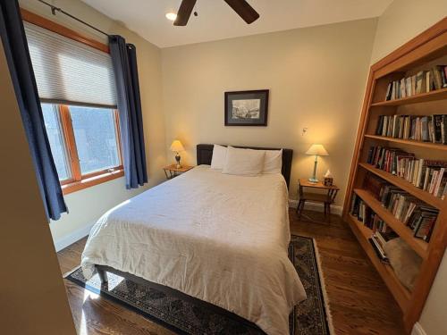 a bedroom with a bed and a book shelf at Life on the Lake in Colchester