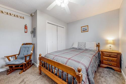 a bedroom with a bed and a chair at Downtown Beauty - Unit 1 in Conway