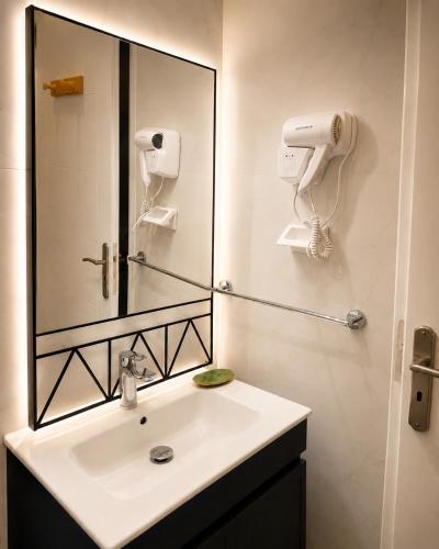a bathroom with a sink and a mirror at Blueyes in Tunis