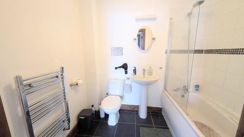 a bathroom with a toilet and a sink and a shower at CJ Maison - "Spacious Family Friendly 2-Bedroom Apartment in the City Centre with free on-site parking, free Wi-Fi" in Southampton