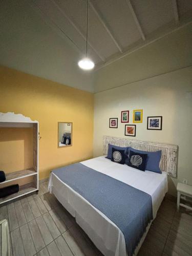 a bedroom with a large bed and a tv at Pousada Anturio Centro in Barra Velha