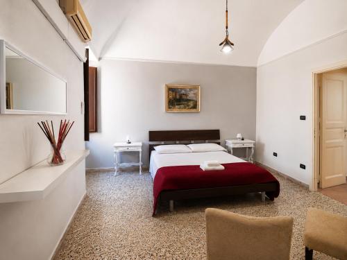 a bedroom with a bed and two tables and a chair at Il Castello di Atessa in Atessa