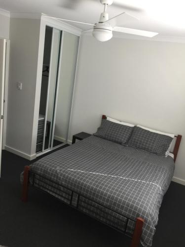 a bedroom with a bed and a ceiling fan at Falcon Bay 4x4 Townhouse in Wannanup