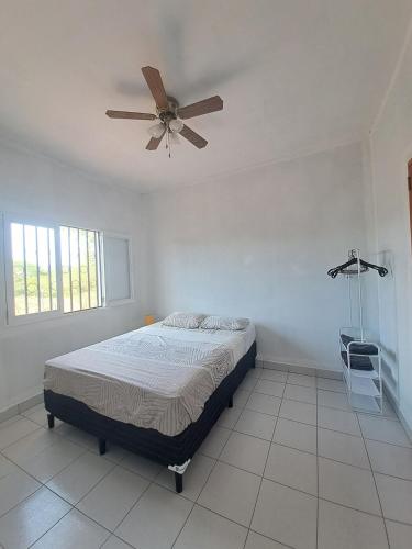 a bedroom with a bed and a ceiling fan at Maison 3 chambres in Granada