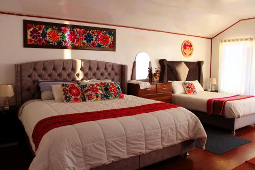 a bedroom with a large bed and a dresser and a bedsenalsenalsenal at Titicaca Mia Lodge Perú in Puno