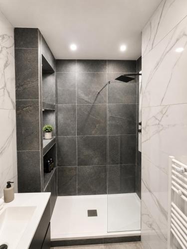 a shower with a glass door in a bathroom at Le Refuge de Chateau Renard in Château-Renard