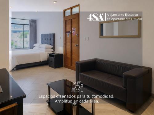 a living room with a couch and a bed at 4StudioAparts RC 01 in Cajamarca