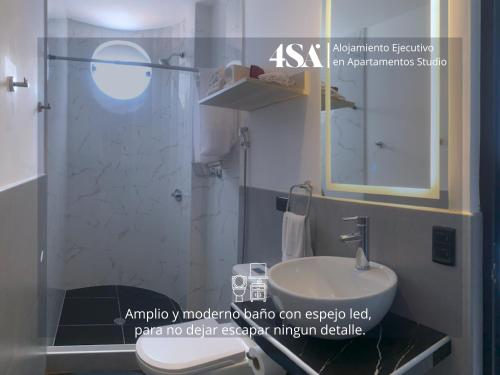 a bathroom with a white sink and a shower at 4StudioAparts RC 01 in Cajamarca