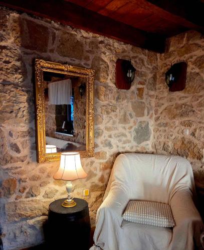 a mirror and a chair in a room with a lamp at Holiday home in Dobrinj - Insel Krk 27652 in Dobrinj